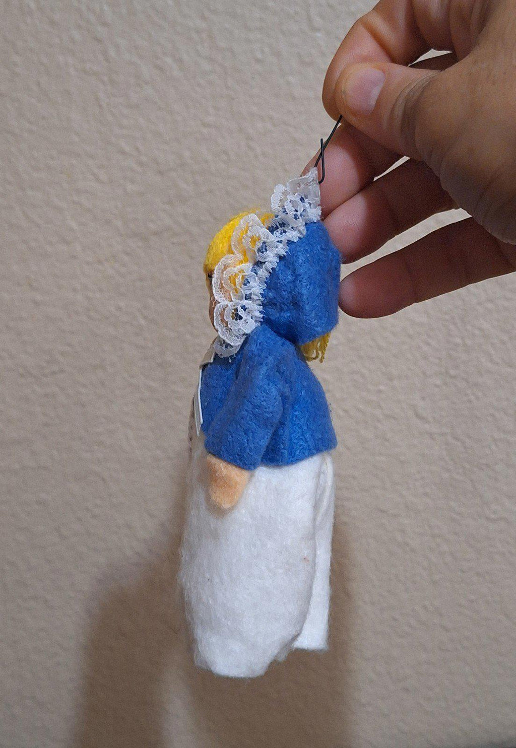 Handmade pilgrim girl ornament figurine side view, blue hood and white apron dress