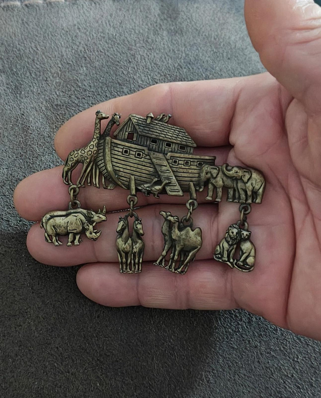 Gold Noah’s Ark brooch pin showing ark roof and hanging zoo-animal figures