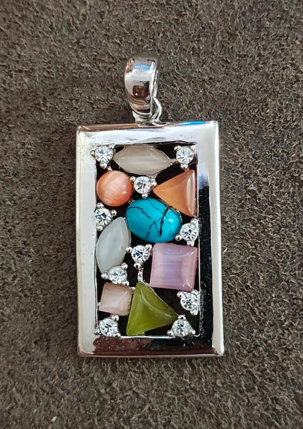 Silver-tone rectangular pendant with turquoise teardrop stone and multicolor inset stones in silver frame