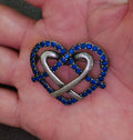 Heart brooch pin with blue rhinestone border and pewter-tone ribbon heart design