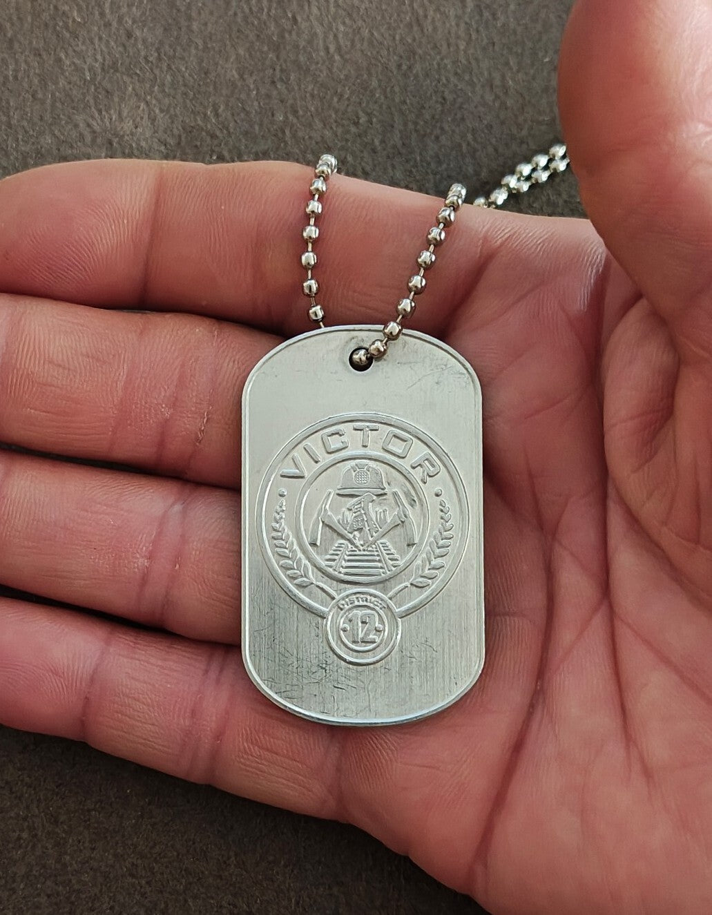 Promotional "The Hunger Games: Catching Fire" District 12 Victor Dog Tag