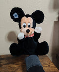 Black plush Mickey Mouse hand puppet with white-gloved hands and red bow tie