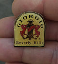 Gold-tone enamel crest pin with red and black lion, "Beverly Hills" text