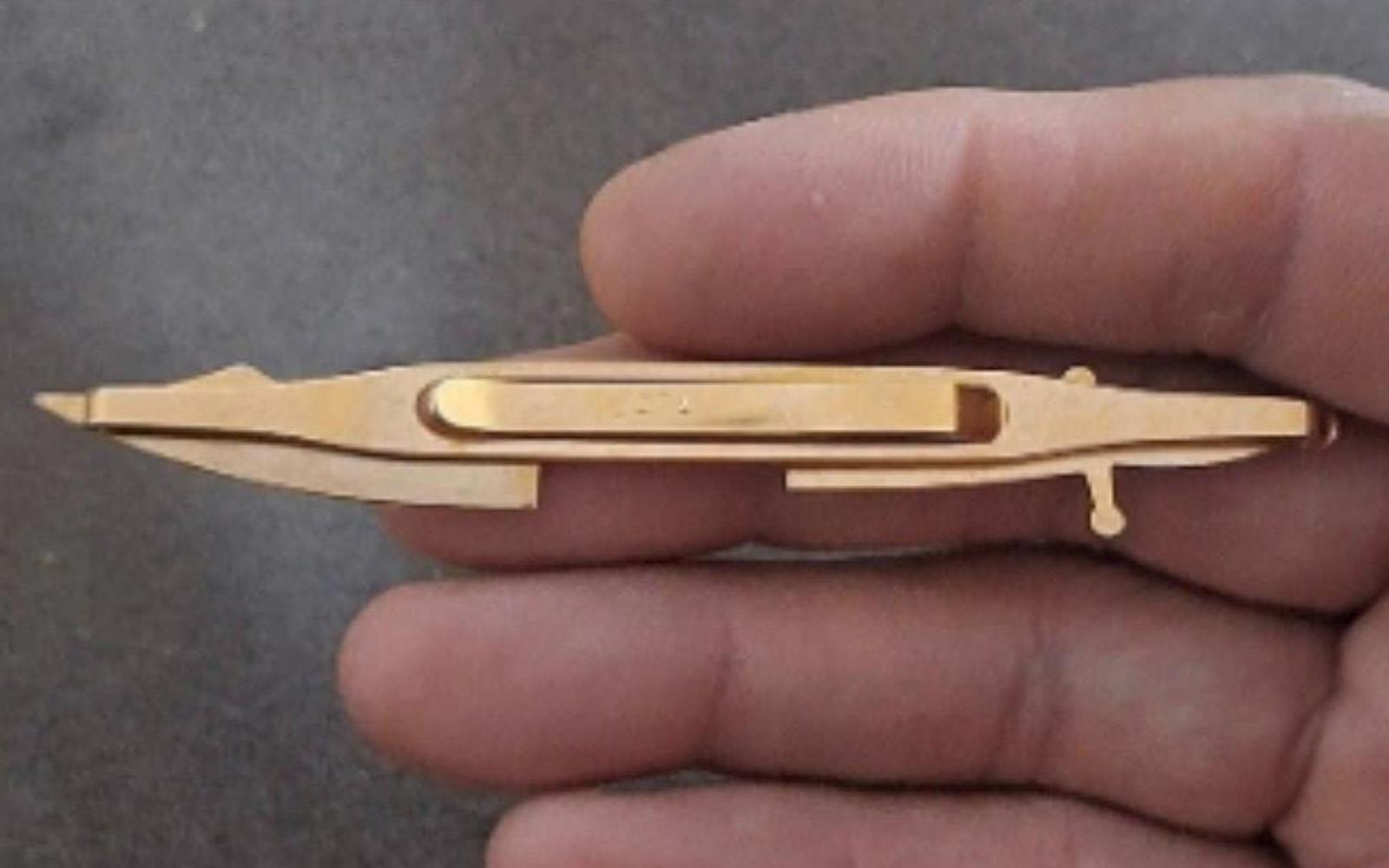 Gold pirate sword tie clip bar viewed from the side, open center window detail