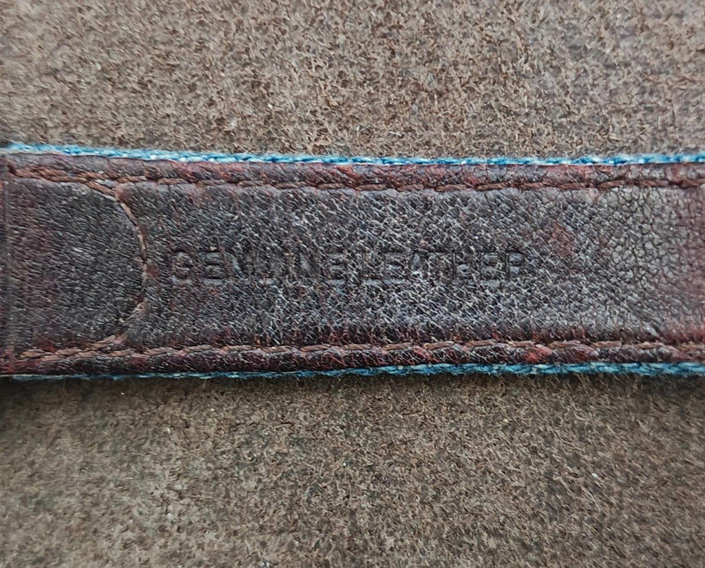 Blue fabric watch strap with dark leather lining and stitched edge