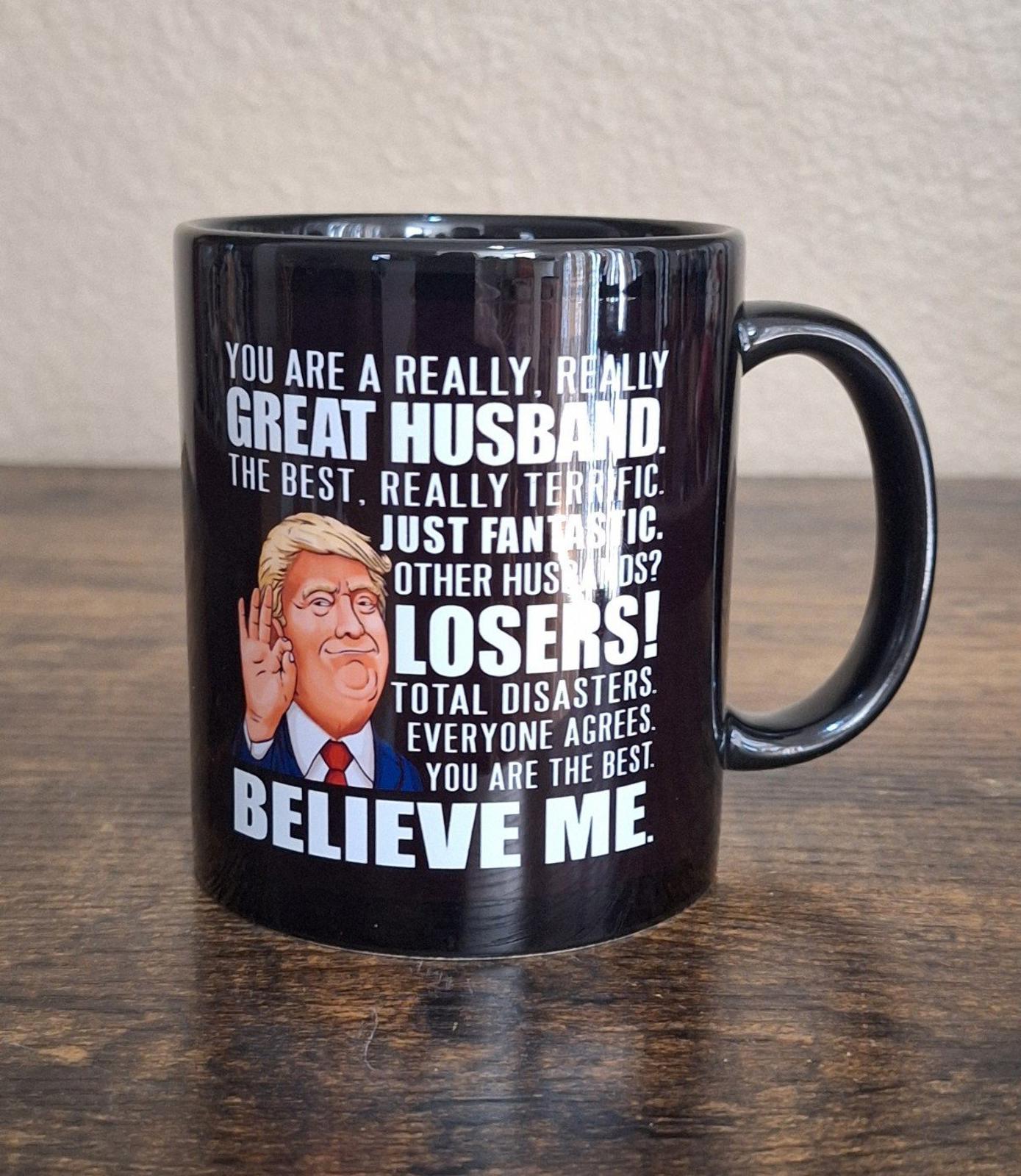 Black ceramic 11 oz mug with "Great Husband" quote and cartoon Donald Trump illustration