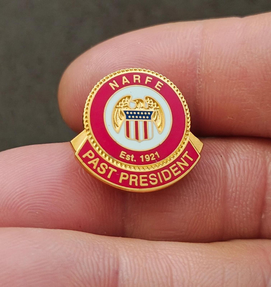 Red and gold enamel association pin close-up, “PAST PRESIDENT” and “Est. 1921”