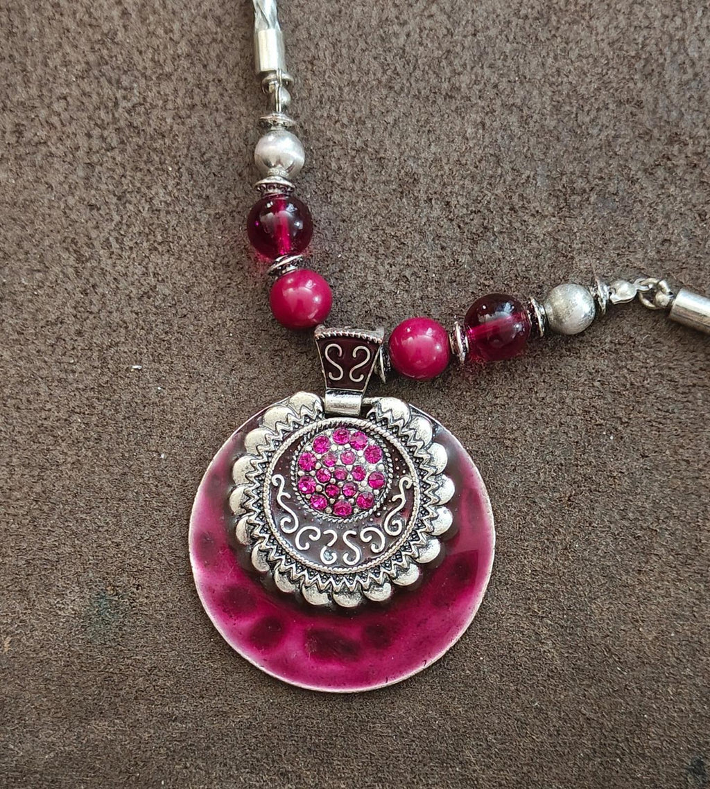 Round burgundy pendant necklace with pink bead strand and silver-tone bail
