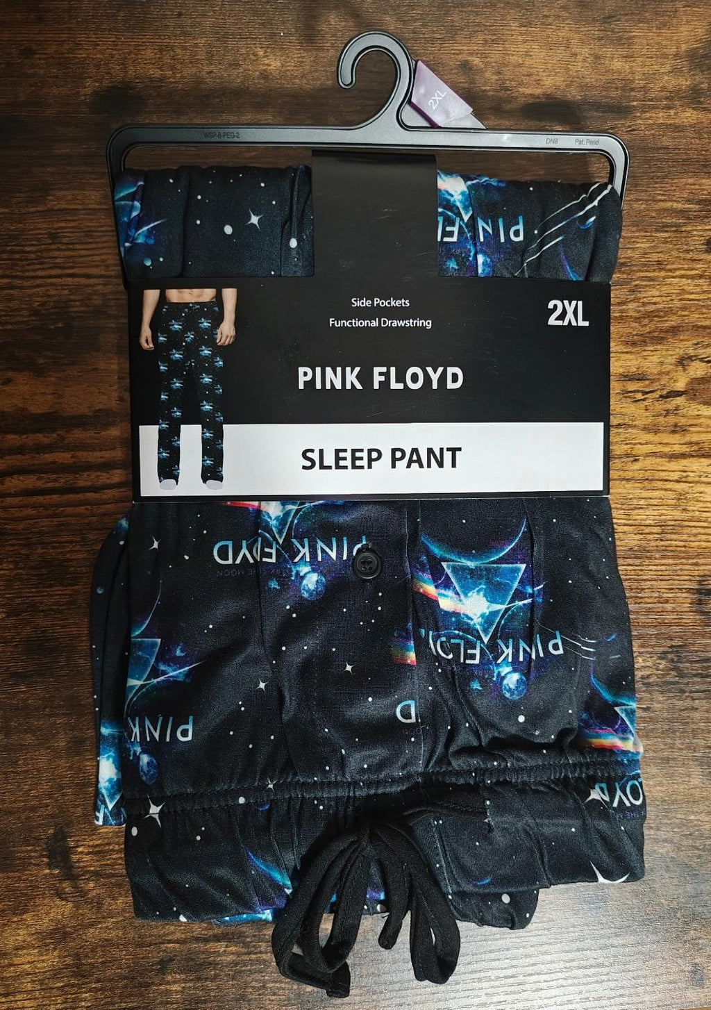 Black graphic sleep pants on hanger with drawstring waist and starry blue design