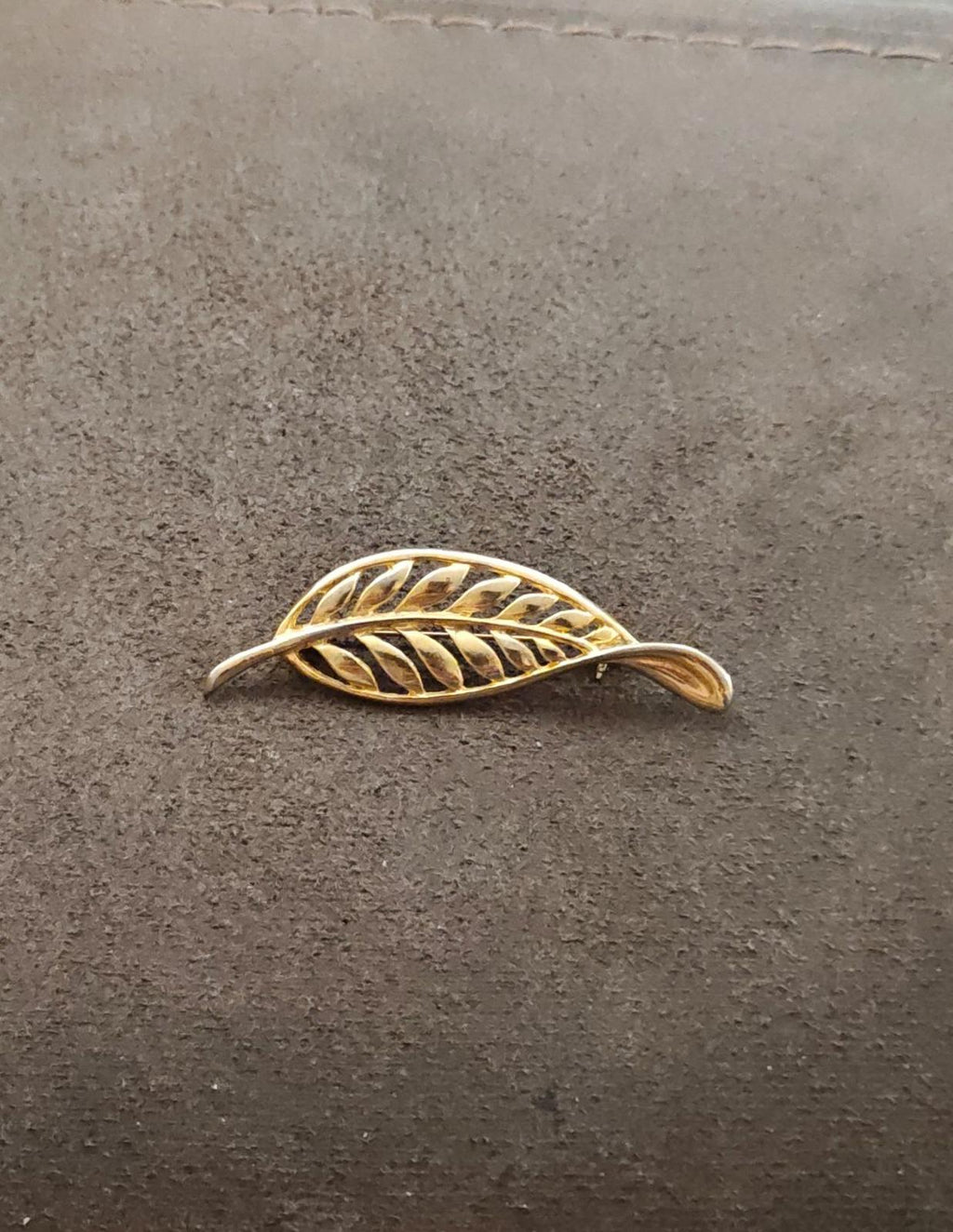 Gold tone leaf brooch with openwork filigree feather motif, side view