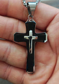 Black and silver cross pendant necklace with small silver-tone bail and chain links