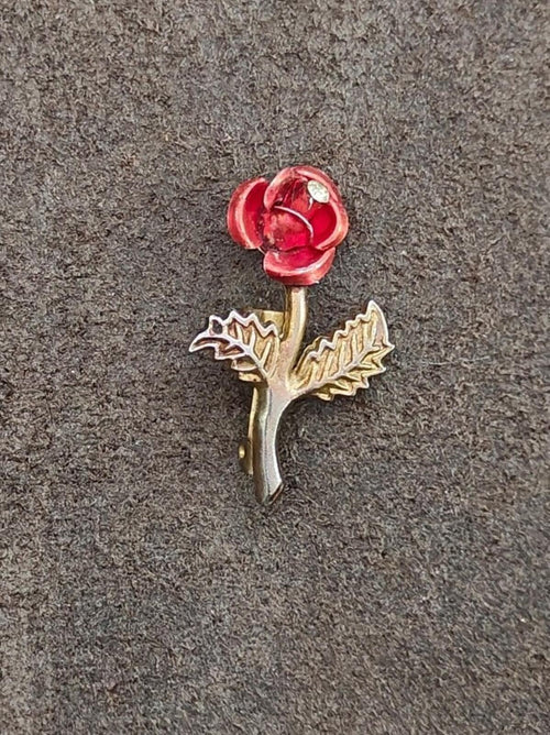 Gold-tone flower pin with red enamel rose petals and clear rhinestone center