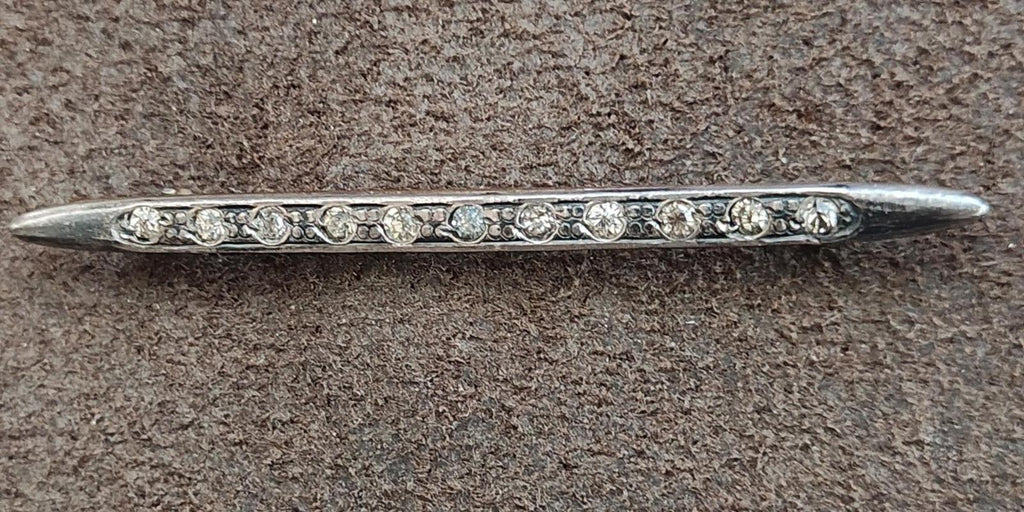 Silver bar brooch with clear rhinestone rows along the top edge