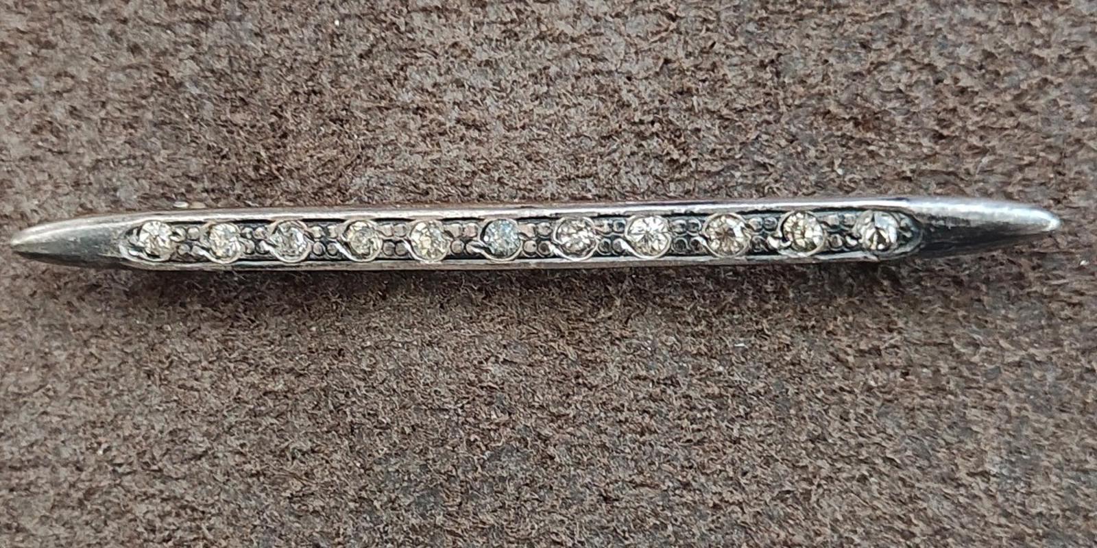 Silver bar brooch with clear rhinestone rows along the top edge