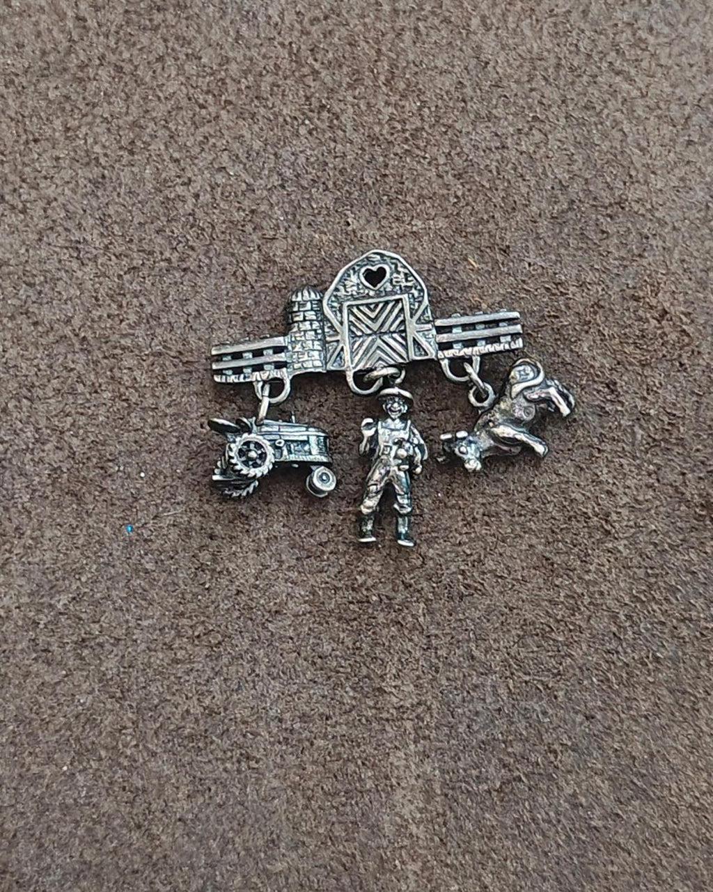 Antiqued sterling silver farm dangle pin with barn and heart motif, tractor, cowboy, and dog