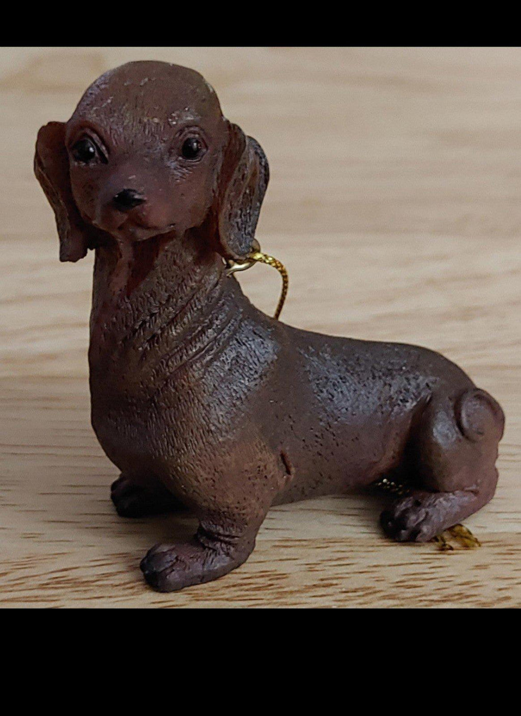 Chocolate brown dachshund Christmas ornament figurine with gold hanging loop