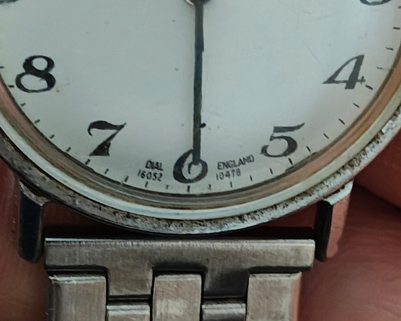Timex Mercury watch face close-up with Arabic numerals and minute marks on silver