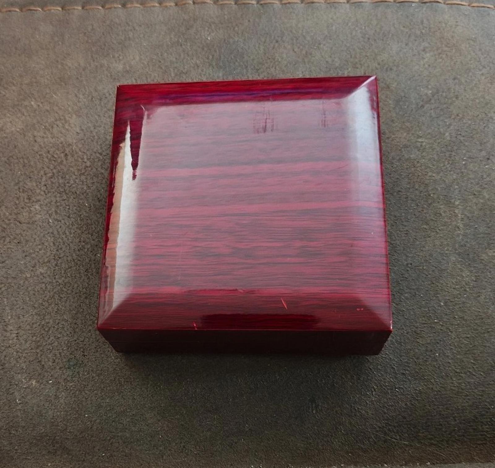 Red jewelry gift box with open lid and padded insert