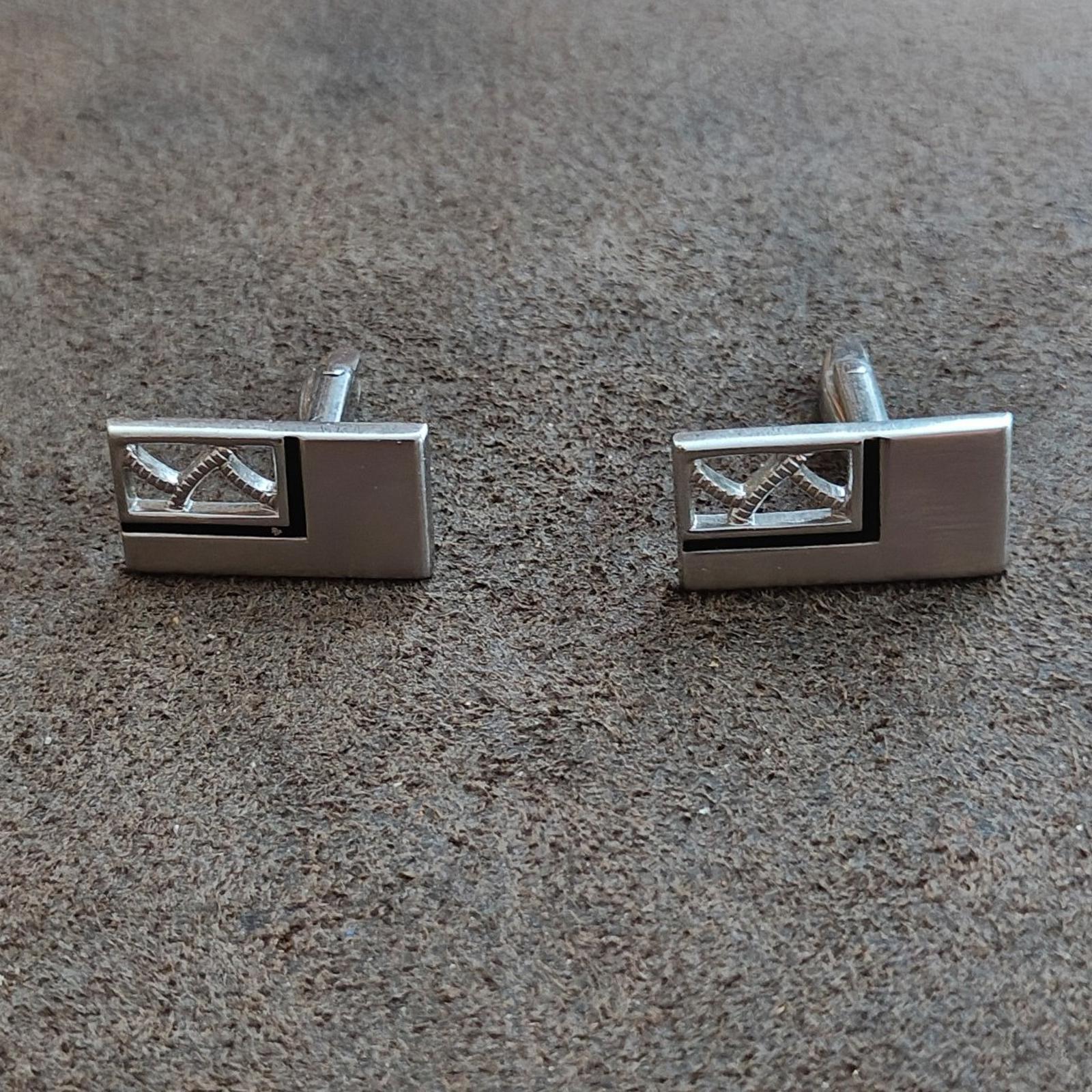 Silver-tone rectangular cufflinks with dark enamel and white geometric inlays