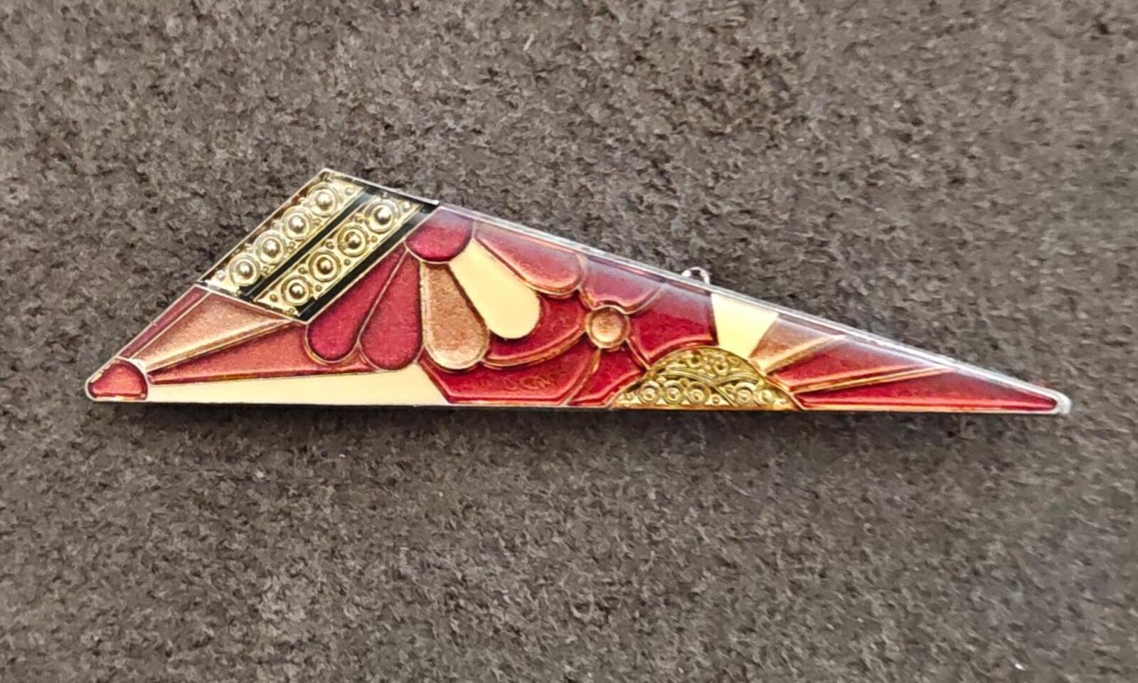 Slim geometric art deco enamel brooch featuring red, gold, and cream accents