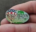 Silver-tone enamel lapel pin, oval design with green balloon and blue star banner