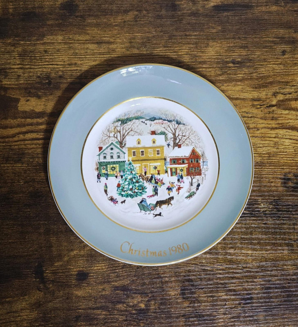 Light blue Avon Country Christmas porcelain plate featuring 1980 village scene and gold trim