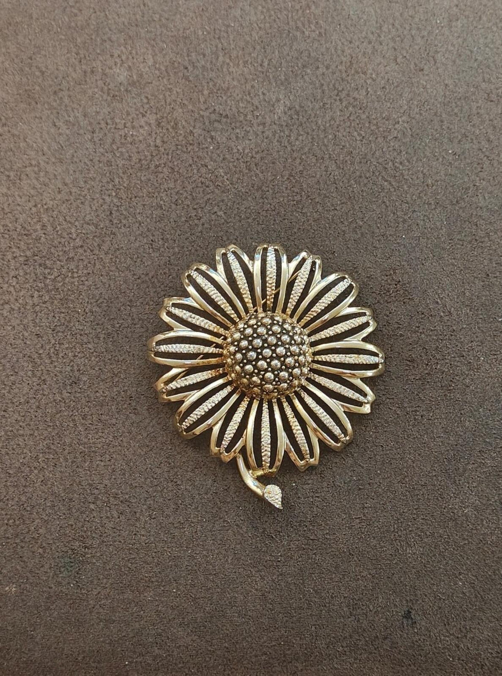 Gold tone sunflower brooch with rhinestone center, scalloped petal rays, small loop bale