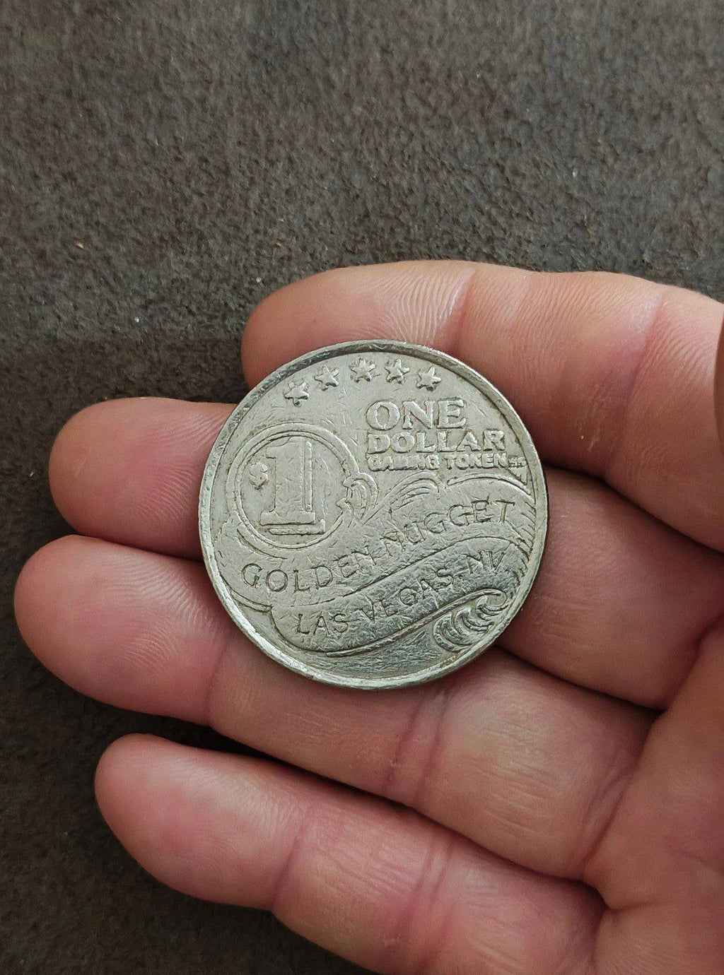 Silver Golden Nugget one-dollar slot token with ONE DOLLAR and LAS VEGAS text.