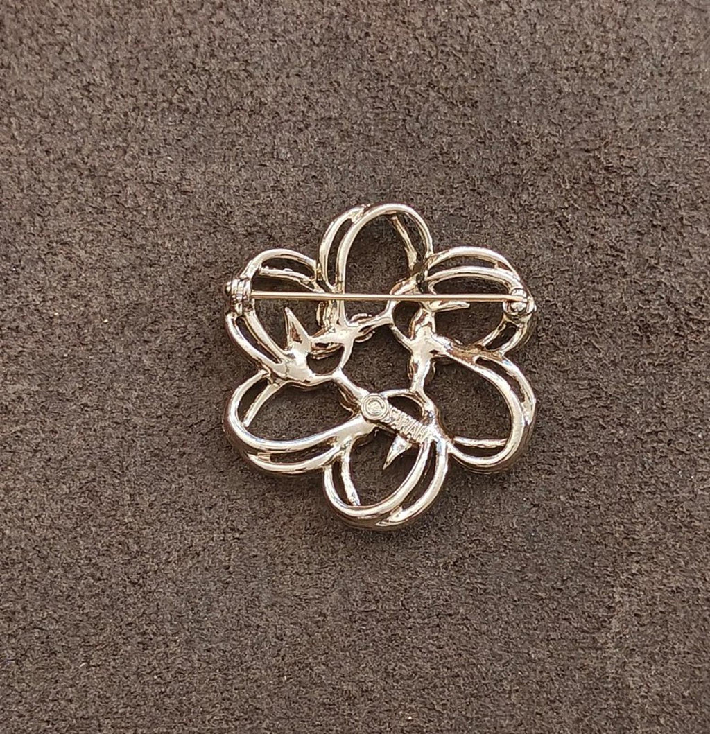 Gold-tone flower brooch with openwork petals and a straight pin bar at back