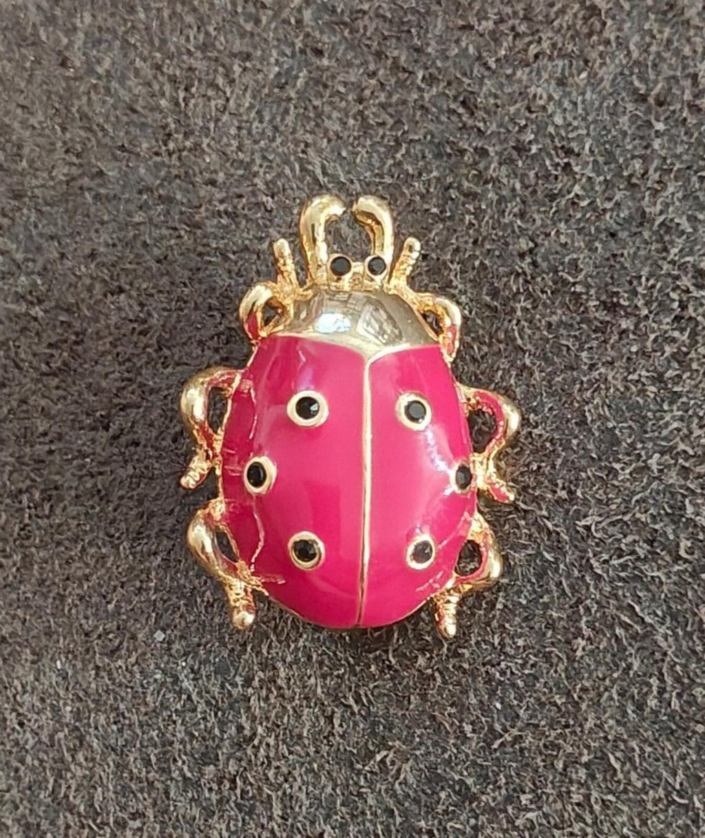 Small gold-tone ladybug pin with red enamel wings and black dot detailing