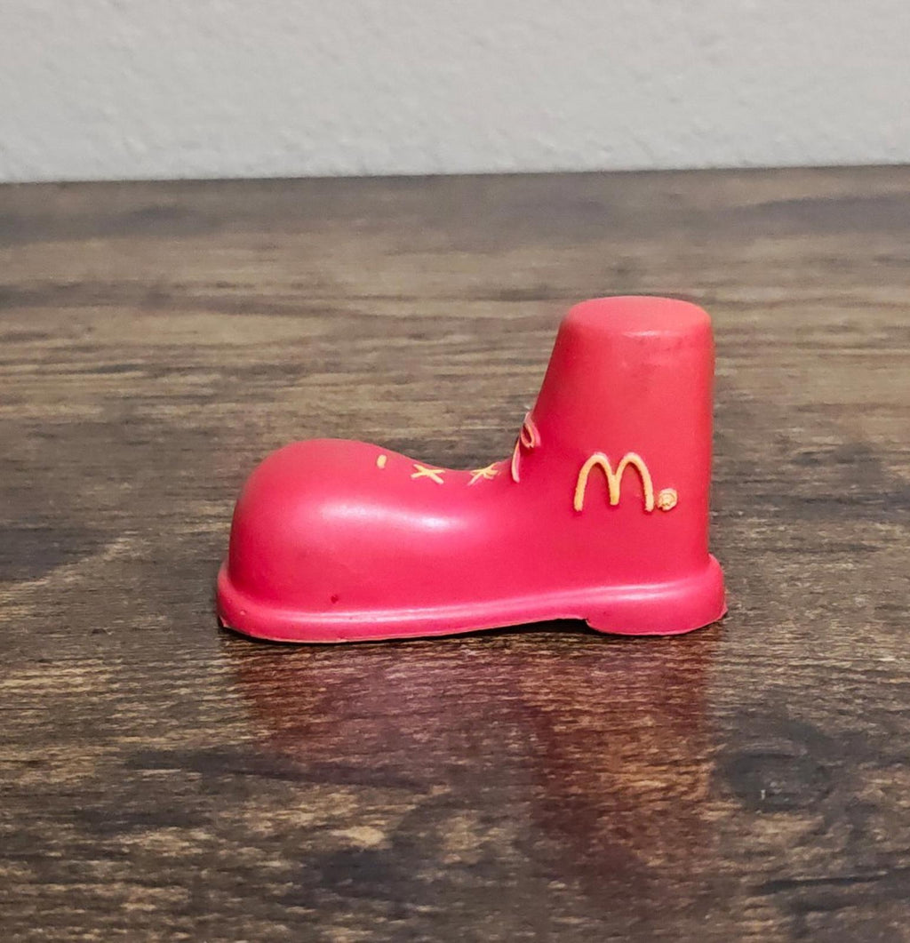 Red boot antenna topper figurine standing on heel, gold McDonald's logo visible