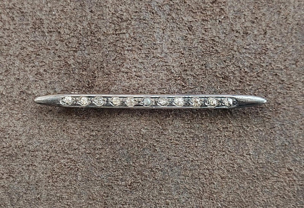 Silver bar brooch with clear rhinestone center row, viewed from the side