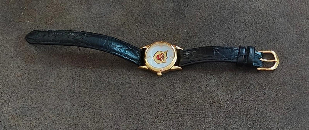 Gold-tone quartz wristwatch with black leather strap and Mickey-style case detail.