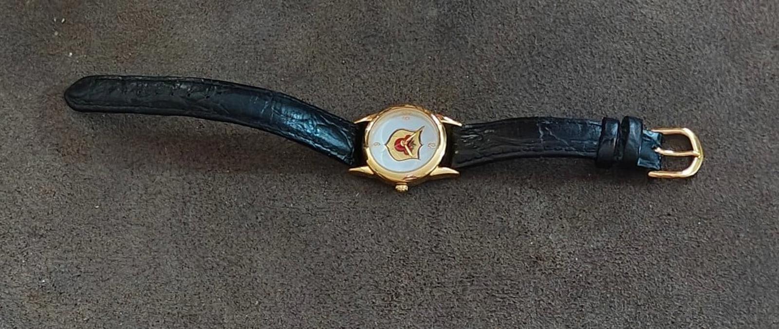 Gold-tone quartz wristwatch with black leather strap and Mickey-style case detail.