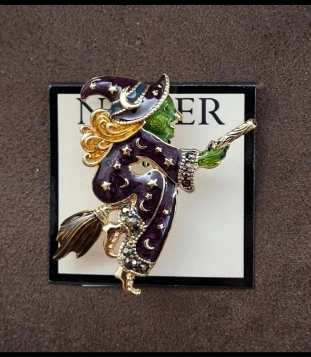 Gold-tone witch enamel pin brooch with dark purple details, green broom, star accents