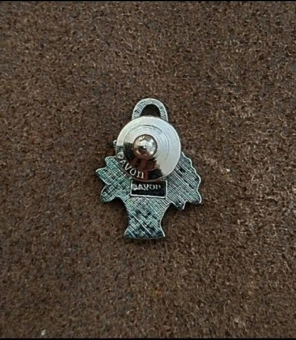 Antiqued silver-tone flower basket pinback with clasp and circular fastener