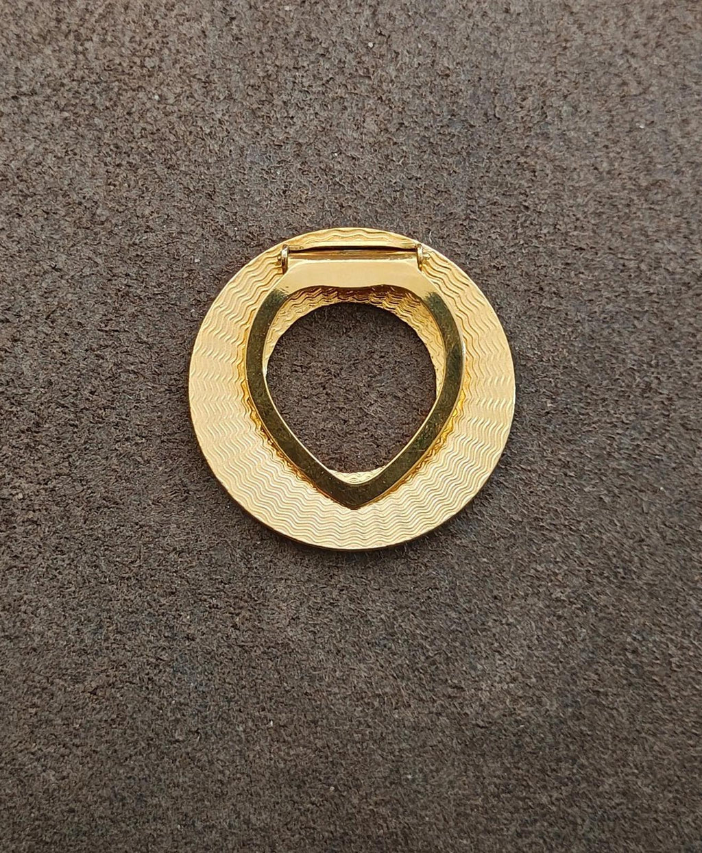 Gold-tone round scarf clip with textured face and triangular clasp loop