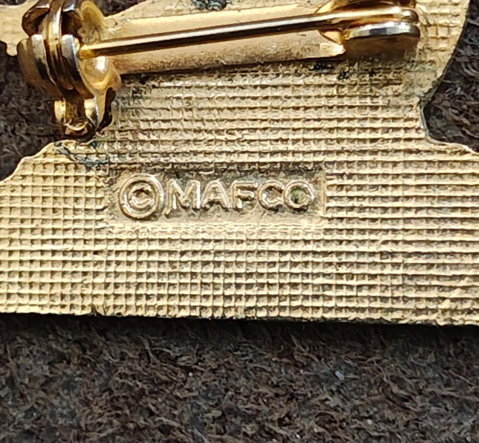 Gold-tone pin back close-up stamped “OMAFCO”