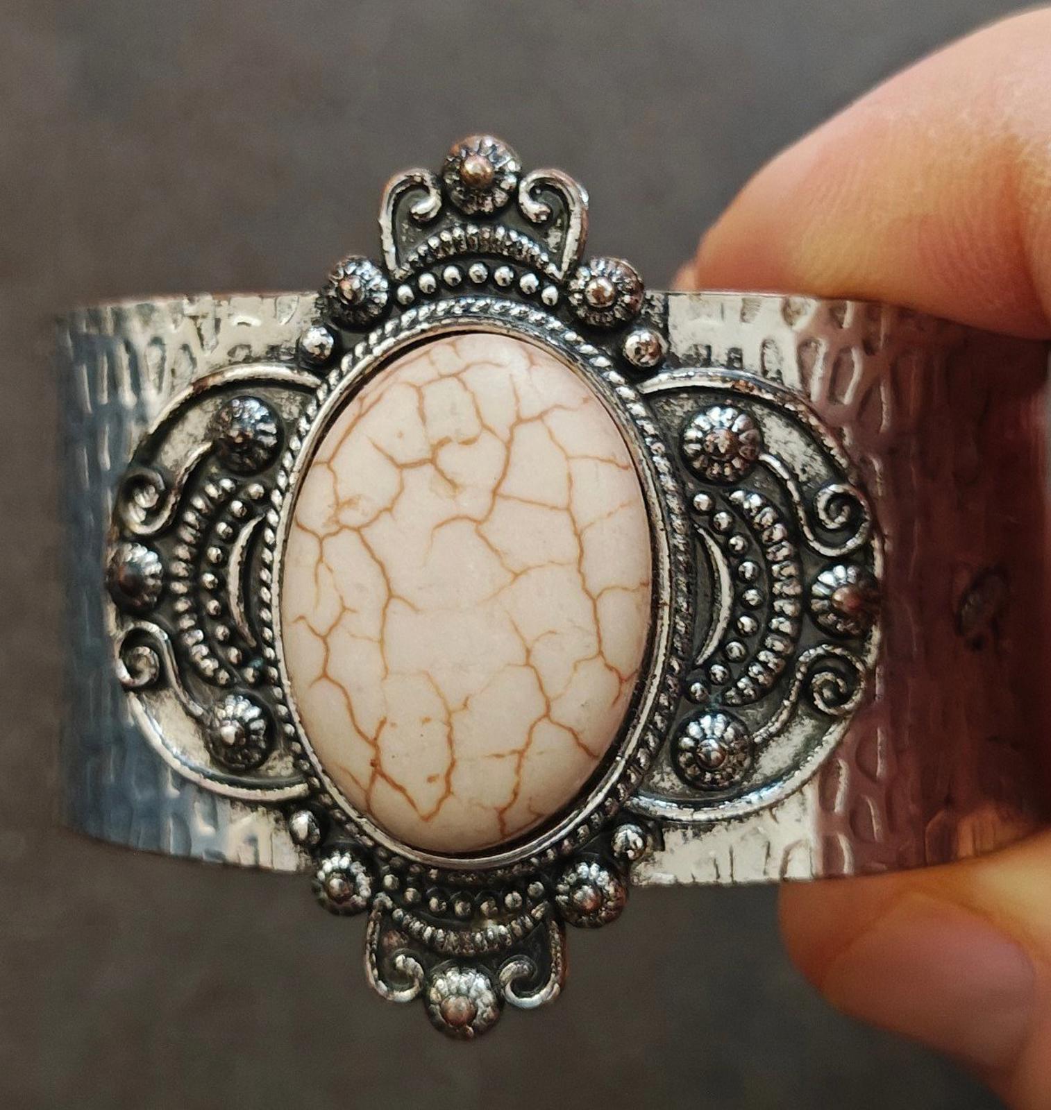 Silver hammered cuff bracelet with oval beige stone and ornate bezel, wide adjustable fit