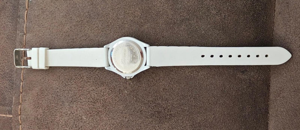 White silicone watch strap with round silver-tone case back and clasp closure