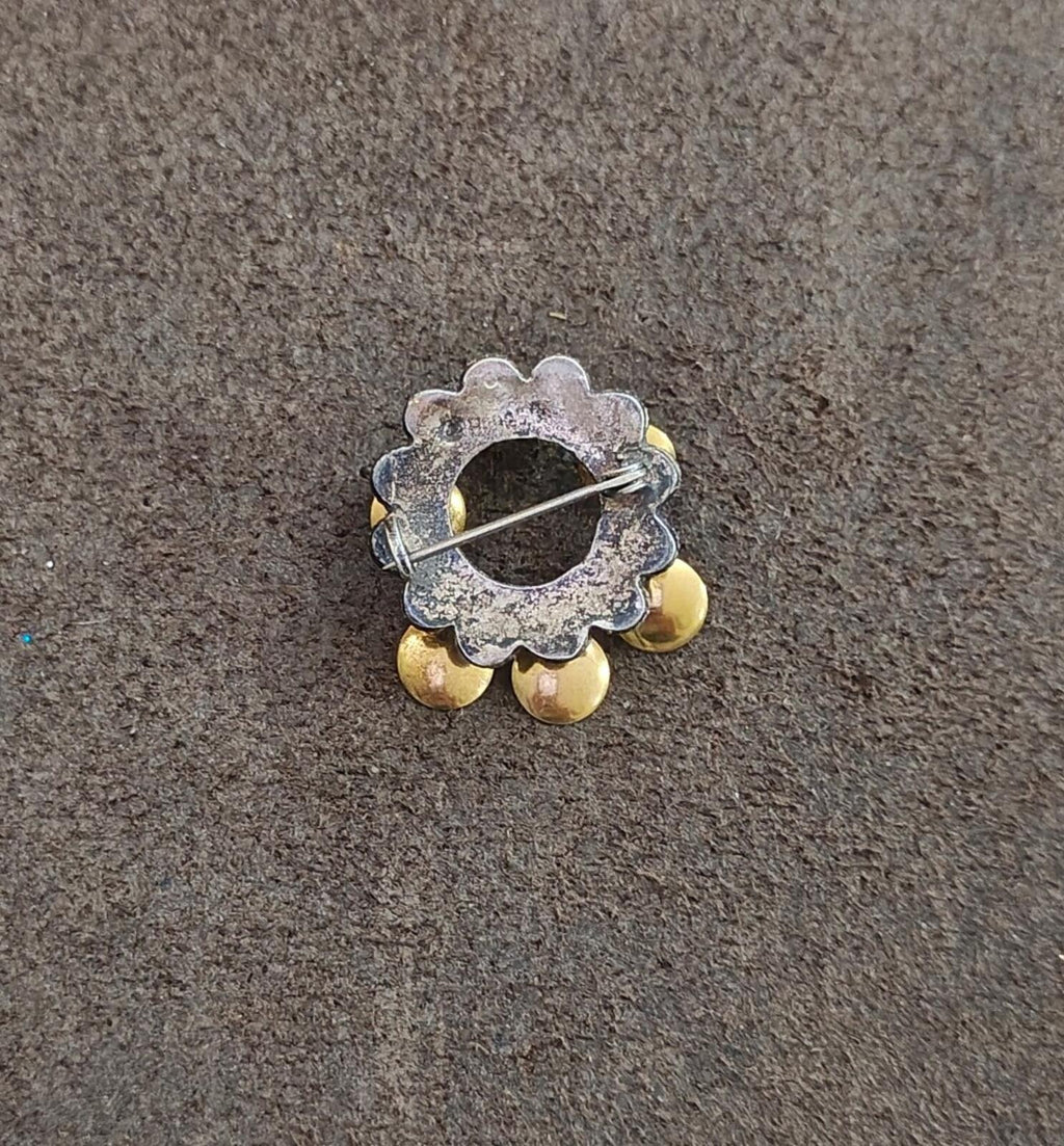 Norwegian brooch back view with silver pin and gold-toned disc accents