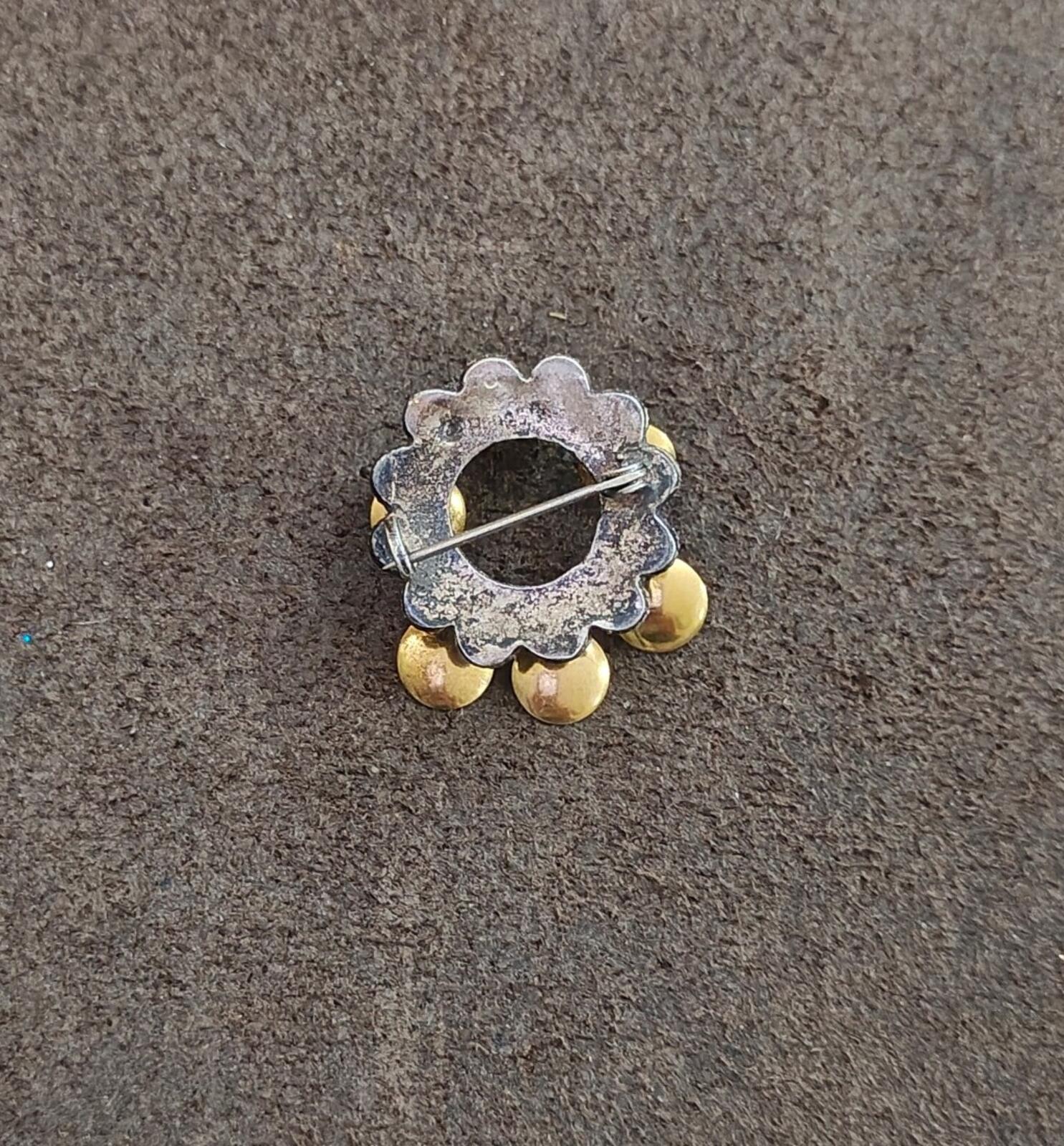 Norwegian brooch back view with silver pin and gold-toned disc accents
