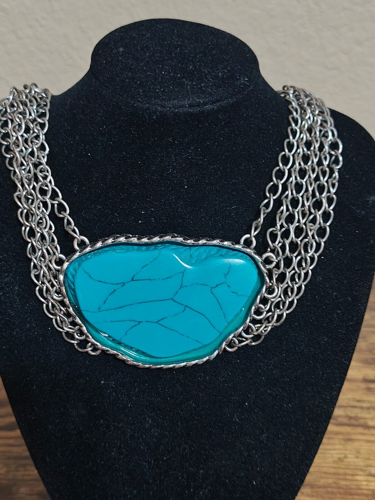Silver Tone Multi Strand Chain Statement Necklace With a Faux Turquoise Stone