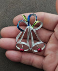 Bell-shaped Christmas brooch pin with blue and green enamel, red bead accents on silver tone