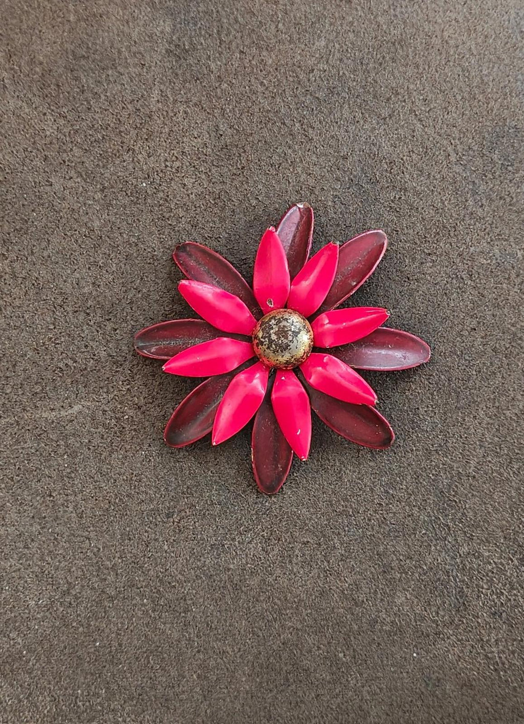 Daisy-shaped red and burgundy enamel pin brooch with glittery gold-toned center