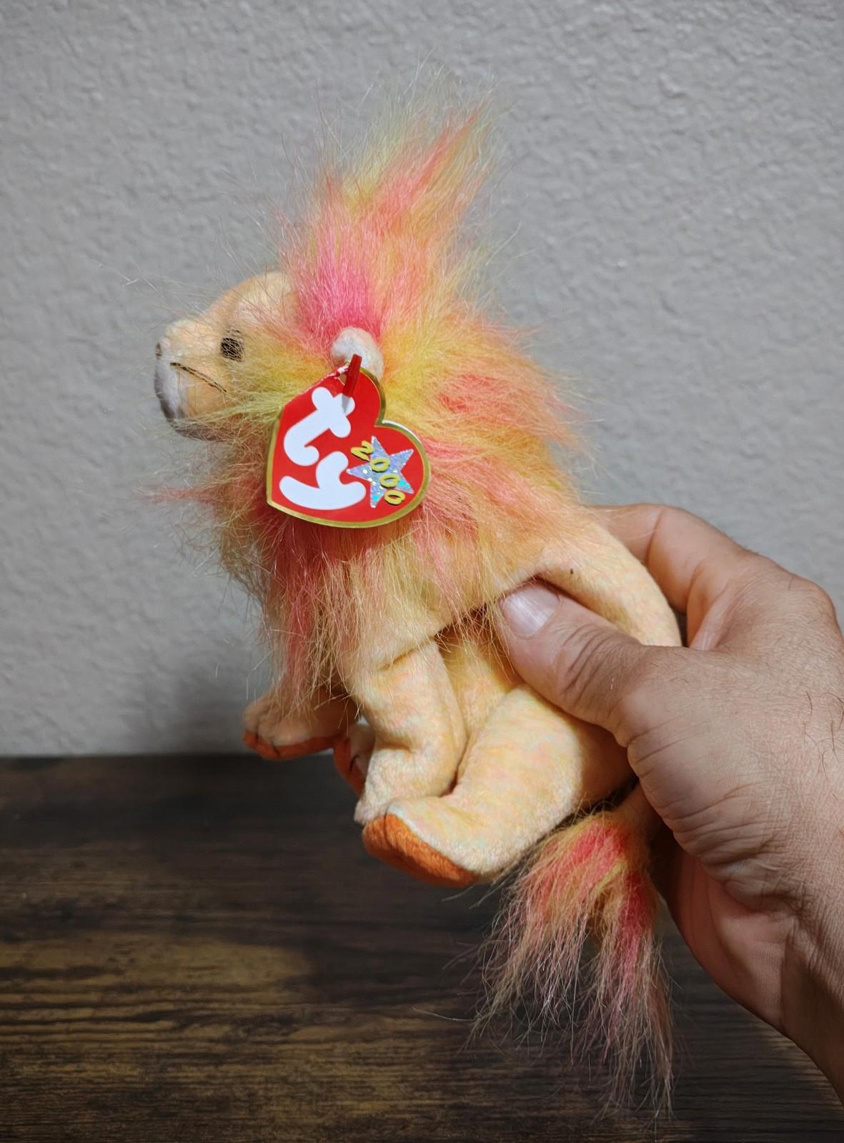 Rainbow-furred lion beanbag plush with red TY heart tag