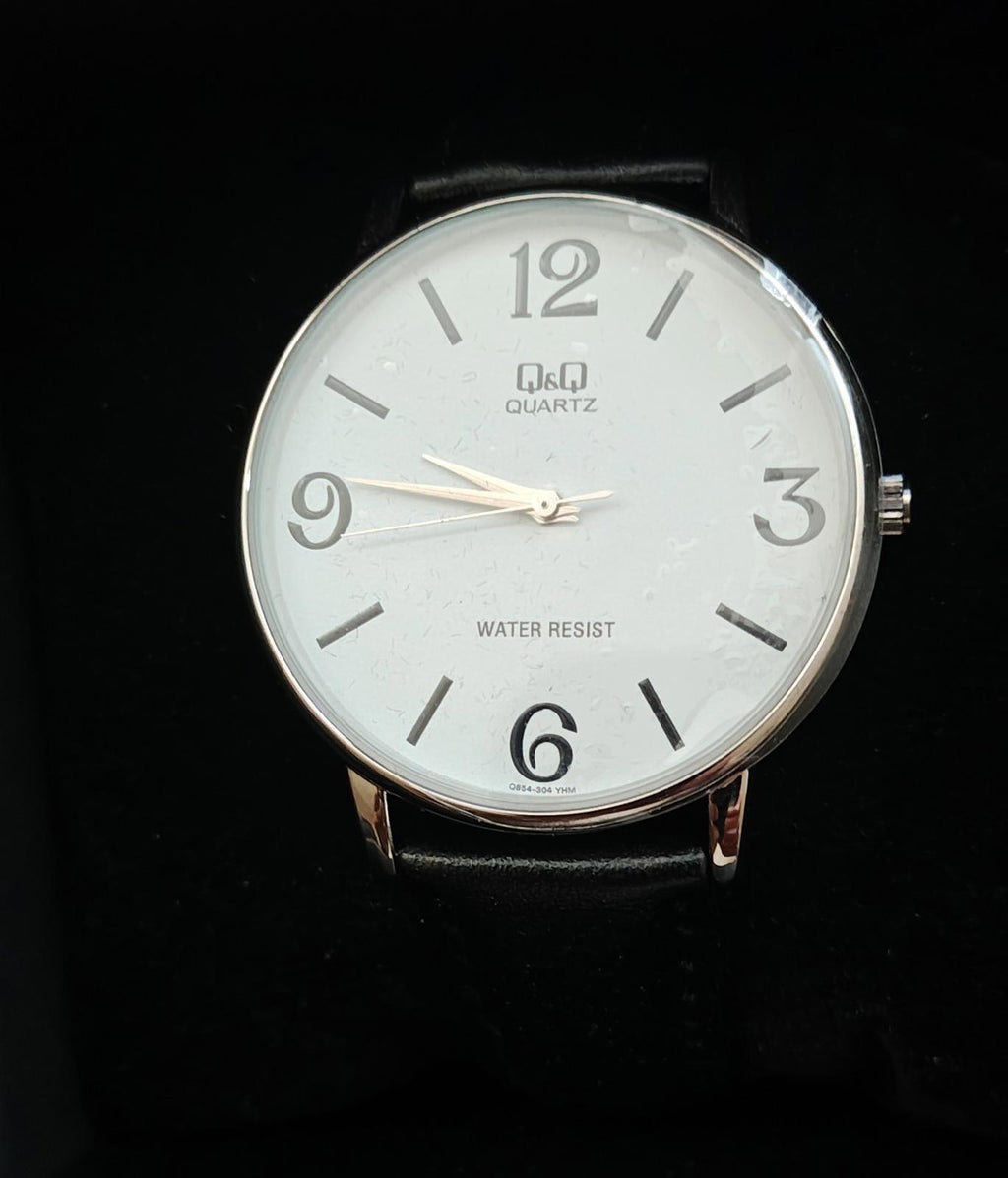 Men's analog wrist watch dial with white face, water resist text