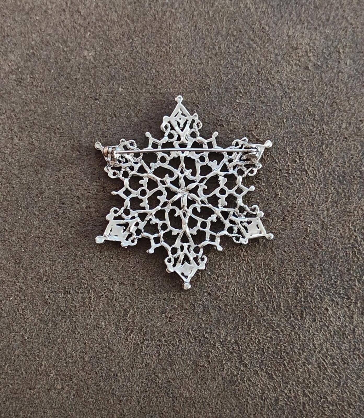 1990s Silver Tone Filigree Snowflake With Clear Rhinestone Accents Brooch.