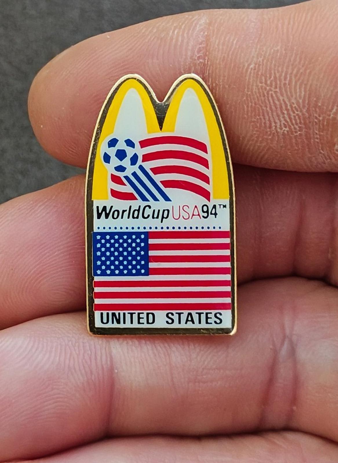 Gold-tone lapel pin featuring McDonald's arch, WorldCup USA '94 text, and U.S. flag