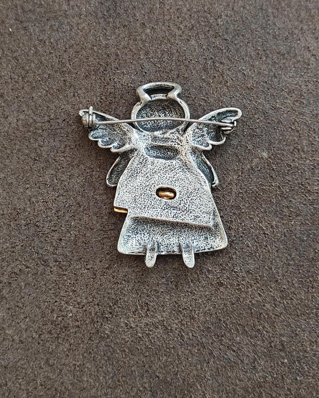 Silver angel brooch back view with pin stem and catch, winged design